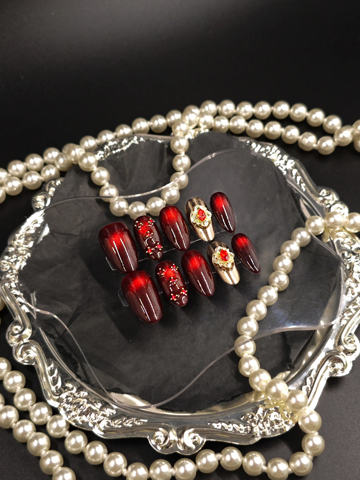 Burgundy Red Cat‑Eye Ornate Gold Gem Medium Almond Nails