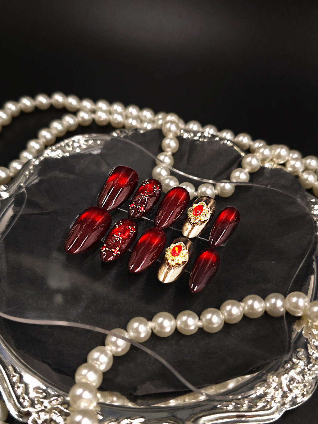 Burgundy Red Cat‑Eye Ornate Gold Gem Medium Almond Nails