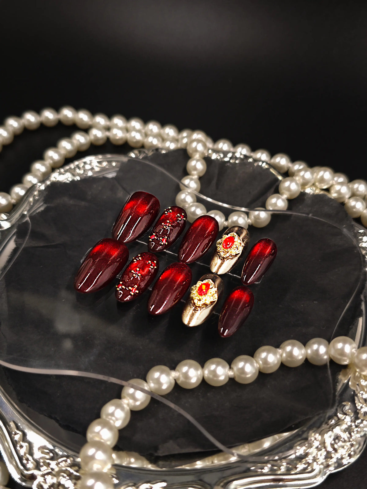 Burgundy Red Cat‑Eye Ornate Gold Gem Medium Almond Nails