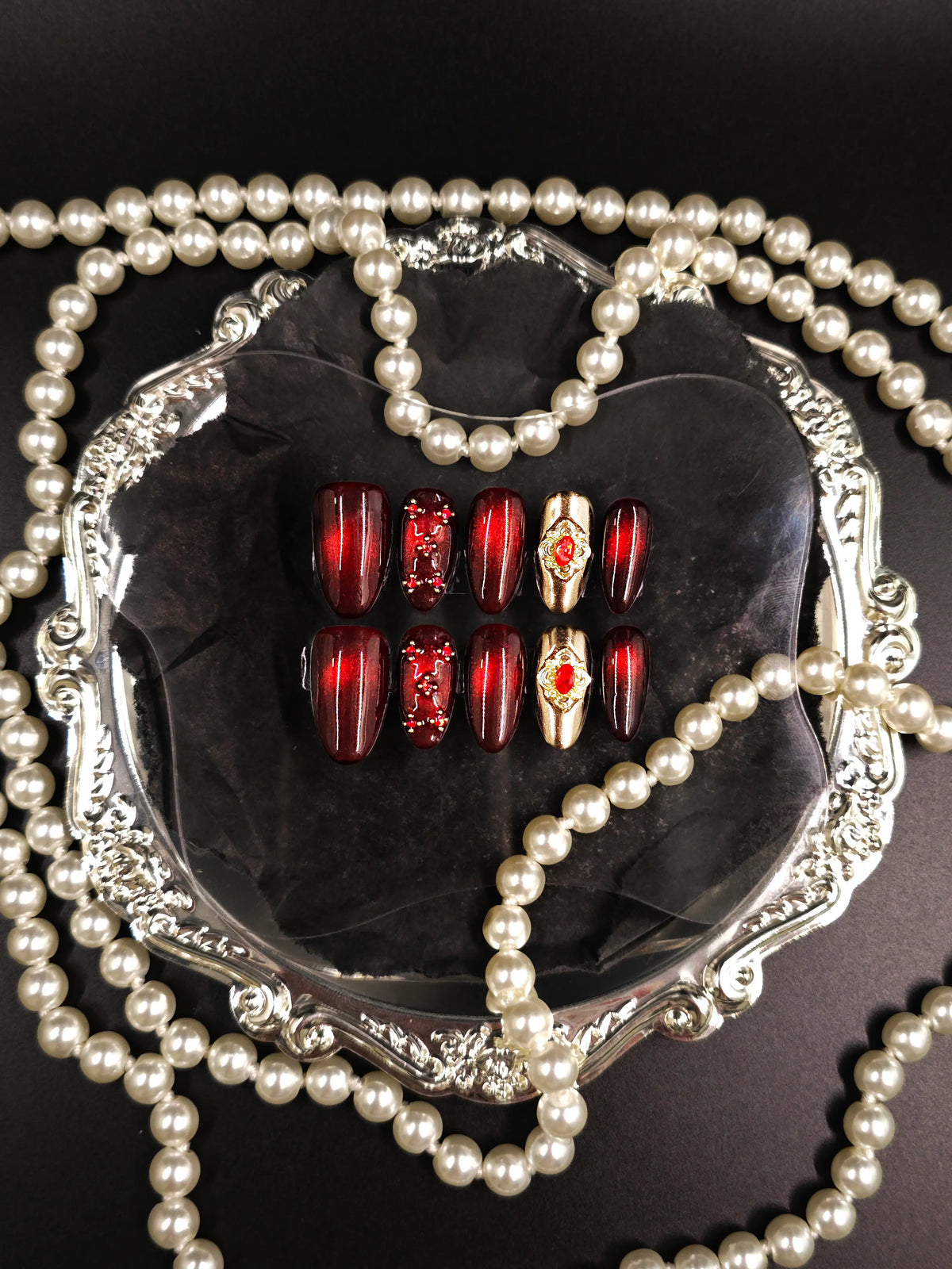 Burgundy Red Cat‑Eye Ornate Gold Gem Medium Almond Nails